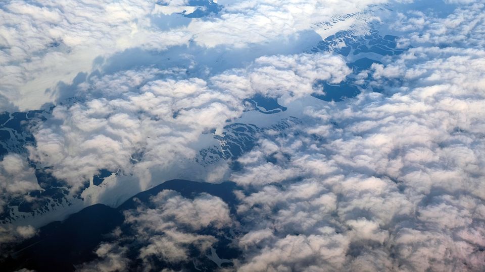 Thick cloud eventually parted to reveal the icy landscape below.