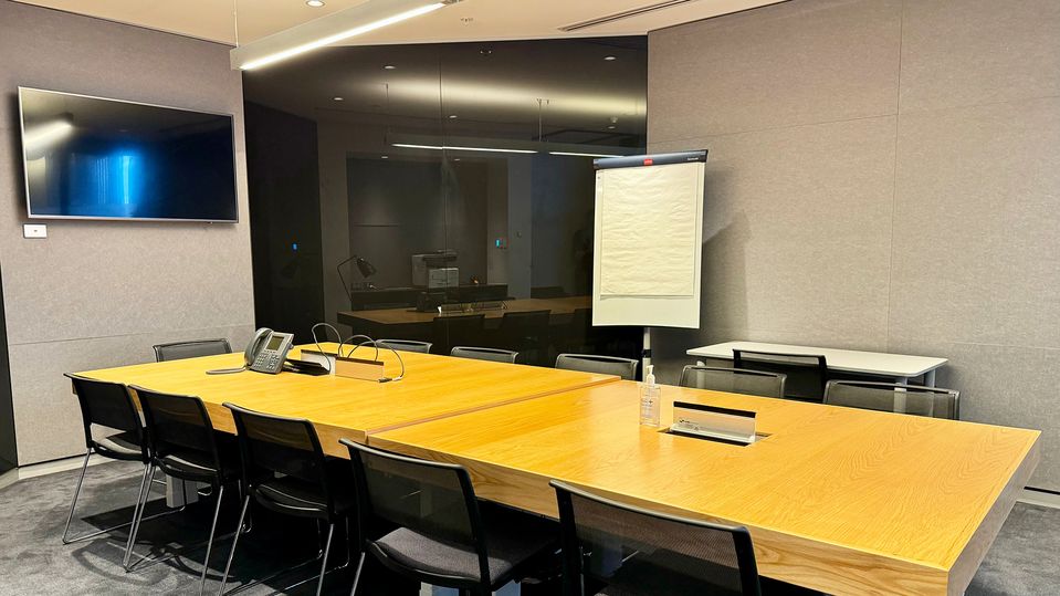 The meeting room houses a TV, printer and paper flipchart.